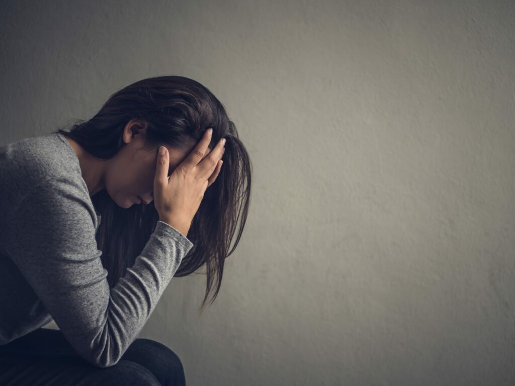 A woman stressed with her hands in her hair