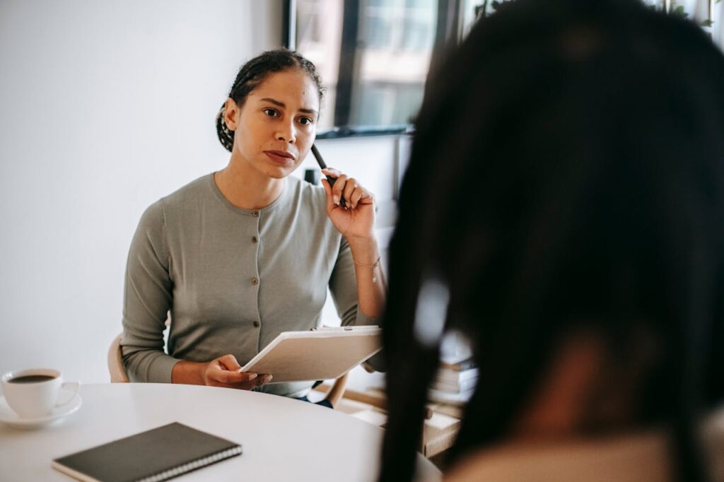 A woman making notes in a meeting