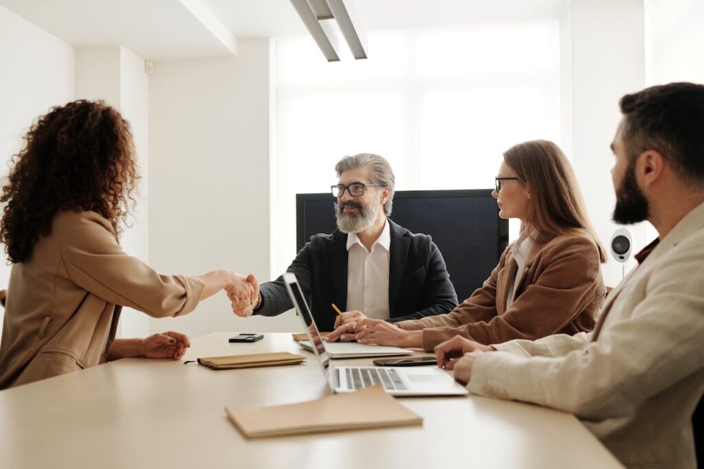People shaking hands in a meeting