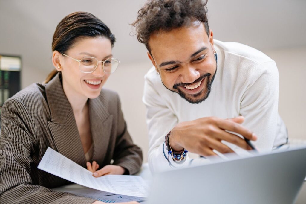 Employees reviewing something on a laptop
