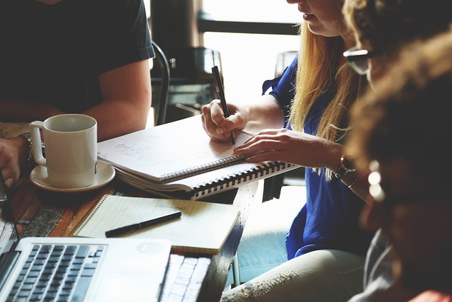 A person taking notes in a meeting