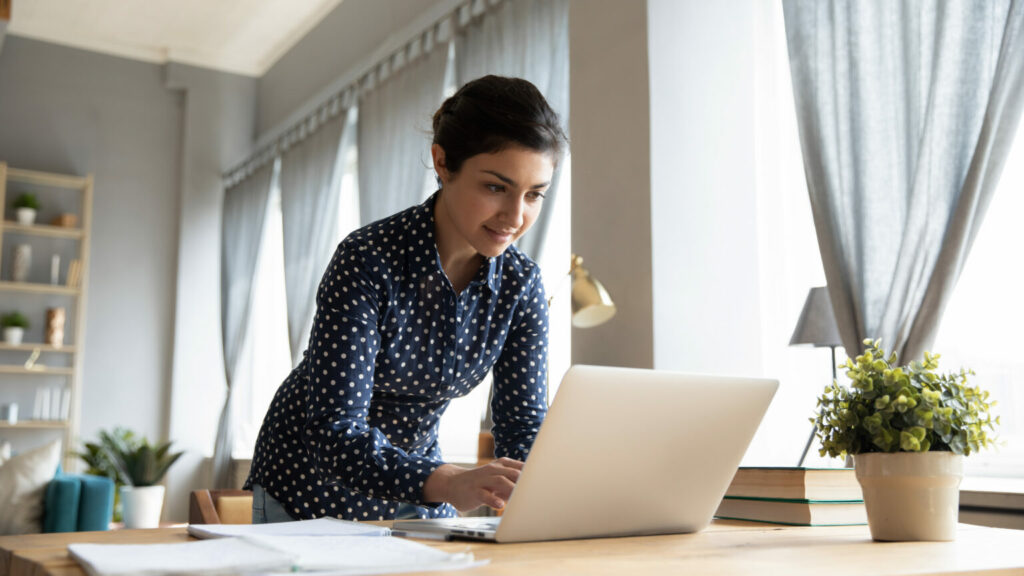 A woman using her work laptop from home