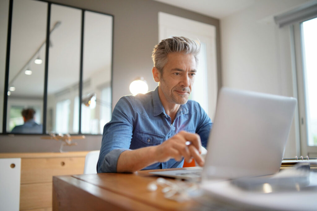 A man using his work laptop from home
